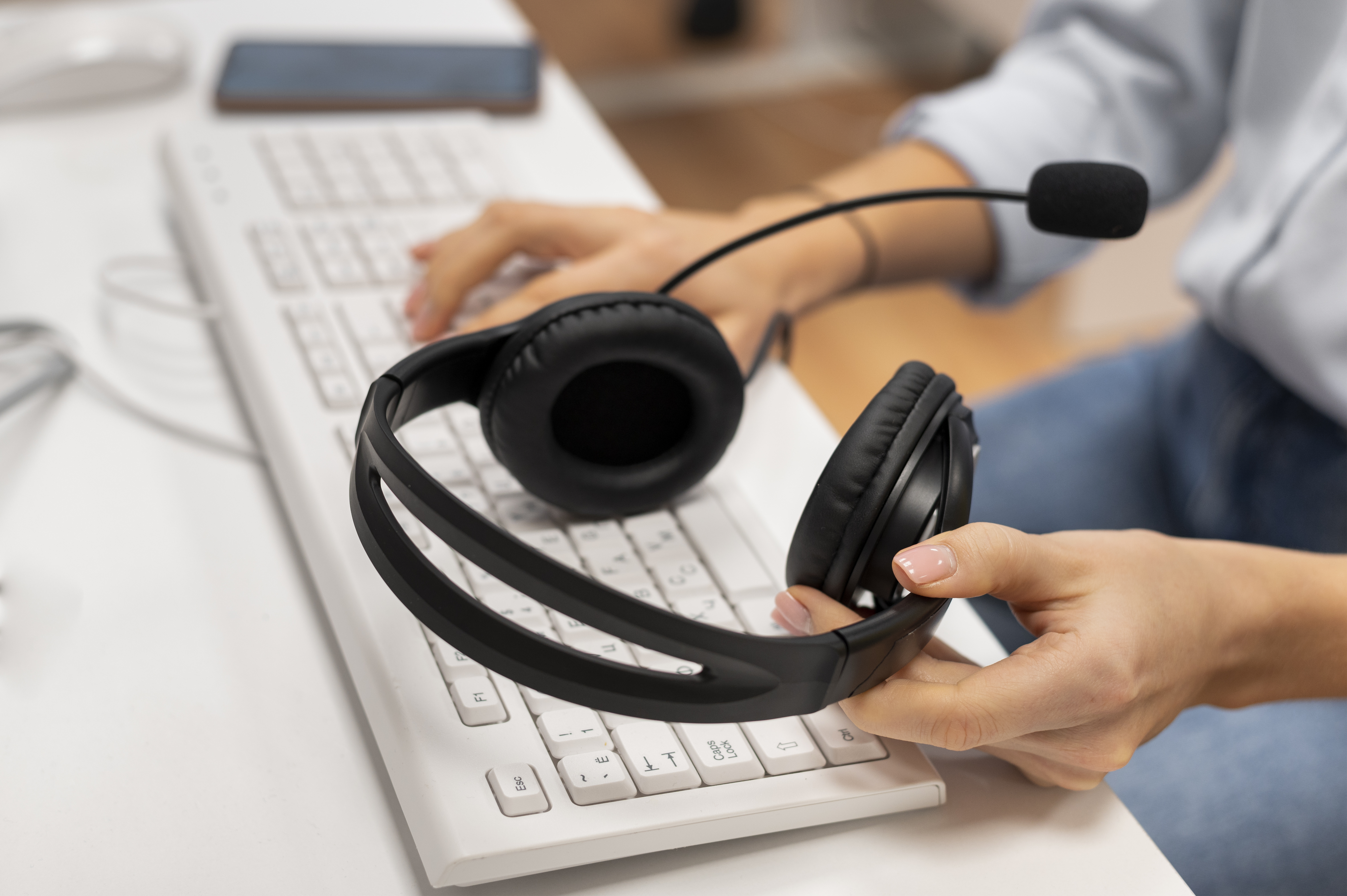 woman working call center holding pair headphones